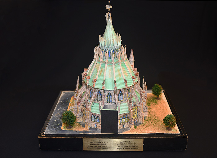 Scale model of the Library of Parliament building, made of colored paper.